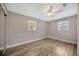 Neutral bedroom with wood floors, ceiling fan and natural light at 1155 Withlacoochee St, Safety Harbor, FL 34695