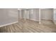 Neutral bedroom featuring a closet with mirrored doors and wood-look flooring at 1155 Withlacoochee St, Safety Harbor, FL 34695