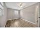 Neutral bedroom with wood floors, ceiling fan and natural light at 1155 Withlacoochee St, Safety Harbor, FL 34695
