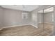 Neutral bedroom with wood floors, closet with mirrored doors and natural light at 1155 Withlacoochee St, Safety Harbor, FL 34695