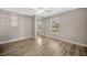Light-filled bedroom with modern flooring, neutral walls, and closet with mirrored doors at 1155 Withlacoochee St, Safety Harbor, FL 34695