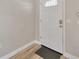 Front door with diamond patterned window above and doormat at 1155 Withlacoochee St, Safety Harbor, FL 34695