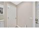 A clean entryway with a storage area and white door, enhanced by fresh paint and new hardware at 1155 Withlacoochee St, Safety Harbor, FL 34695