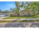 Home exterior displaying well-maintained lawn and landscaped garden, with a detached garage and ample driveway space at 1155 Withlacoochee St, Safety Harbor, FL 34695