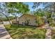 Charming home featuring a well-manicured lawn and garden, with mature trees offering shade and curb appeal at 1155 Withlacoochee St, Safety Harbor, FL 34695