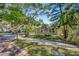 Inviting home exterior with a lush front yard, mature trees, and well-maintained lawn, creating a welcoming atmosphere at 1155 Withlacoochee St, Safety Harbor, FL 34695