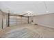 Spacious two-car garage with concrete floor, overhead door, and storage shelves, offering ample parking at 1155 Withlacoochee St, Safety Harbor, FL 34695