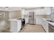 Updated kitchen featuring stainless steel appliances, white cabinetry, quartz countertops, and modern flooring at 1155 Withlacoochee St, Safety Harbor, FL 34695