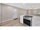 Modern kitchen with stainless steel appliances, a large island with quartz countertops, and stylish flooring at 1155 Withlacoochee St, Safety Harbor, FL 34695