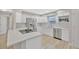 Modern kitchen features stainless steel appliances, white cabinets, and stone countertops at 1155 Withlacoochee St, Safety Harbor, FL 34695