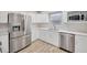 Well-equipped kitchen featuring stainless steel appliances, quartz counters and white cabinets, ideal for cooking and entertaining at 1155 Withlacoochee St, Safety Harbor, FL 34695