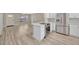 Spacious kitchen with white cabinets, quartz countertops, a stainless steel stove, and modern flooring at 1155 Withlacoochee St, Safety Harbor, FL 34695