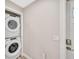 Laundry room with stacked washer and dryer, next to door with new hardware and fresh paint at 1155 Withlacoochee St, Safety Harbor, FL 34695