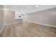 Open-concept living room with modern flooring, fans, and view of the kitchen at 1155 Withlacoochee St, Safety Harbor, FL 34695