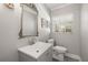 Bathroom with single sink, vanity, toilet, and window with blinds at 1211 S Druid Ln, Tampa, FL 33629