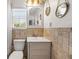 Bathroom with decorative mirror and lighting and tile surround at 1211 S Druid Ln, Tampa, FL 33629
