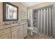 Bathroom featuring granite countertop vanity, marble shower, and decorative tile flooring at 1211 S Druid Ln, Tampa, FL 33629