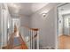 Hallway with wood floors, white trim, and stylish lighting leading to different rooms at 1211 S Druid Ln, Tampa, FL 33629