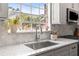 Up close view of the kitchen counter with sink, modern faucet, and white stone countertops at 1211 S Druid Ln, Tampa, FL 33629