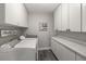 Laundry room with front load washer and dryer plus storage and folding counter at 1211 S Druid Ln, Tampa, FL 33629