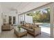 Features a covered patio with stylish furniture and views of the pool and backyard at 1211 S Druid Ln, Tampa, FL 33629