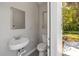 This is the pool house bathroom with a standing sink and commode at 1211 S Druid Ln, Tampa, FL 33629
