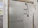 Updated shower featuring marble-look walls, built-in shelves, and a sleek glass door at 1211 S Druid Ln, Tampa, FL 33629