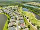 Scenic aerial view featuring the community's well manicured golf course, serene lakes, and beautiful single Gathering homes at 1216 Lyndhurst Greens Dr, Sun City Center, FL 33573