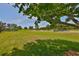Large backyard featuring lush green lawn and a beautiful golf course view at 1216 Lyndhurst Greens Dr, Sun City Center, FL 33573