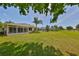 Expansive backyard with lush lawn and access to the neighborhood common area at 1216 Lyndhurst Greens Dr, Sun City Center, FL 33573