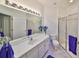 Clean bathroom with white cabinetry, glass shower, and sleek fixtures at 1216 Lyndhurst Greens Dr, Sun City Center, FL 33573