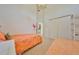 Bright bedroom featuring twin beds, closet, and a partial view of the bathroom at 1216 Lyndhurst Greens Dr, Sun City Center, FL 33573