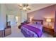 This lovely bedroom has hardwood furniture, is painted light purple, and is illuminated by a ceiling fan at 1216 Lyndhurst Greens Dr, Sun City Center, FL 33573