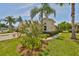Charming home exterior featuring a well-maintained yard, lush landscaping, and a private driveway at 1216 Lyndhurst Greens Dr, Sun City Center, FL 33573