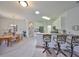 Bright kitchen boasts a breakfast bar with seating, stainless steel appliances, and tile flooring flowing into the dining area at 1216 Lyndhurst Greens Dr, Sun City Center, FL 33573
