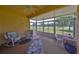 Spacious enclosed lanai with comfortable seating, perfect for relaxation and enjoying the view at 1216 Lyndhurst Greens Dr, Sun City Center, FL 33573