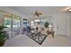 Well-lit living room showcases open access to the outdoor patio and neutral decor at 1216 Lyndhurst Greens Dr, Sun City Center, FL 33573
