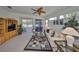 Inviting living room with natural light, a ceiling fan, and sliding door access at 1216 Lyndhurst Greens Dr, Sun City Center, FL 33573