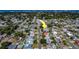 Aerial view showcasing a neighborhood with mature trees, showcasing the home's location and surrounding community at 13057 89Th Ave, Seminole, FL 33776
