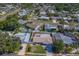 An aerial view showcases a neighborhood with mature trees, pools, and well-maintained homes and lawns at 13057 89Th Ave, Seminole, FL 33776