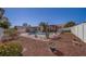 Spacious backyard featuring a pool, lush landscaping, pergola-covered patio, and ample space for outdoor activities at 13057 89Th Ave, Seminole, FL 33776
