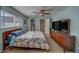 Cozy bedroom features closet, ceiling fan and adjoining bathroom at 13057 89Th Ave, Seminole, FL 33776