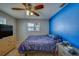 Bedroom with a blue accent wall, ceiling fan, dresser, and natural light at 13057 89Th Ave, Seminole, FL 33776