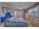 Comfortable bedroom with ceiling fan, plush bed, and natural light from the window at 13057 89Th Ave, Seminole, FL 33776