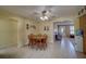 Bright dining room featuring a ceiling fan and adjacent rooms at 13057 89Th Ave, Seminole, FL 33776