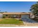 Charming single-story home with a well-maintained lawn and attached two-car garage at 13057 89Th Ave, Seminole, FL 33776