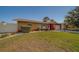 Charming single-story home featuring a well-maintained lawn, an attached garage, and a welcoming front entrance at 13057 89Th Ave, Seminole, FL 33776