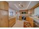 Well-lit kitchen featuring wood cabinets, stainless steel appliances, and tile flooring at 13057 89Th Ave, Seminole, FL 33776