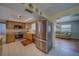 Updated kitchen with stainless steel refrigerator and a view into the adjacent living space at 13057 89Th Ave, Seminole, FL 33776