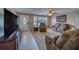 Inviting living room with ample seating, a ceiling fan, and natural light from the window at 13057 89Th Ave, Seminole, FL 33776
